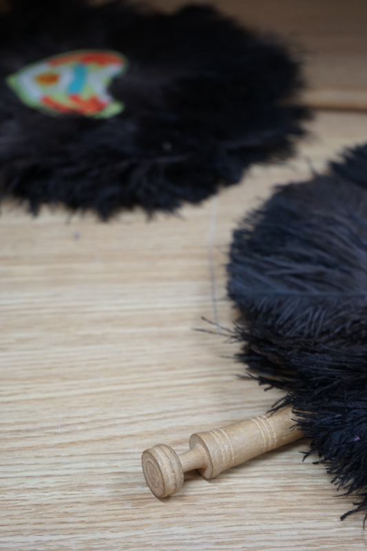 A pair of ostrich feather fans, with embroidered central panels, 45cm high. Condition - good